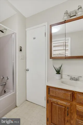 a view of a house with a snow in yard and covered with trees