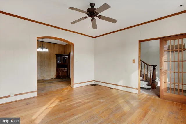 a view of an empty room with window and cabinet