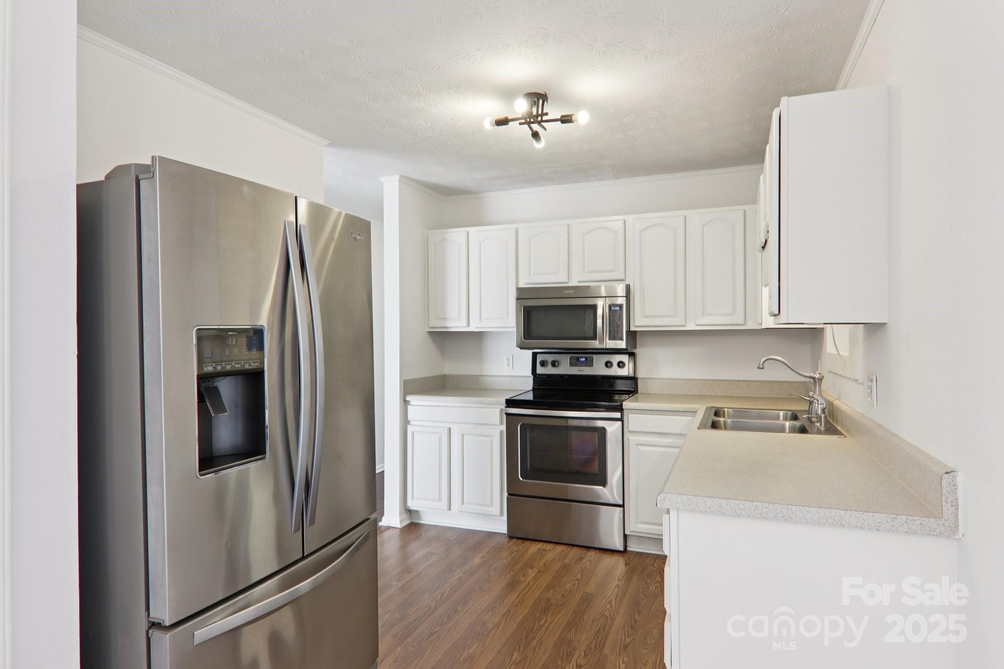591 Blue Ridge Road Black Mountain, NC 28711 - Photo 12 of 32 a kitchen with stainless steel appliances a refrigerator stove and microwave