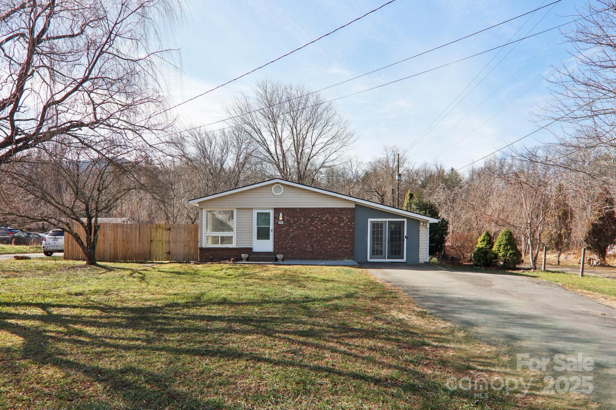 591 Blue Ridge Road Black Mountain, NC 28711 - Photo 2 of 32 a front view of house with yard and trees around