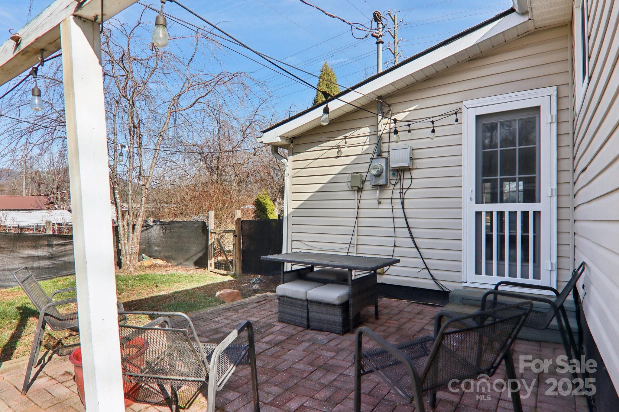 591 Blue Ridge Road Black Mountain, NC 28711 - Photo 25 of 32 a view of a patio with table and chairs with wooden floor and fence