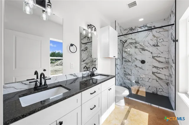 a bathroom with a double vanity sink mirror double and shower