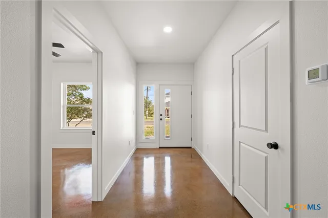 a view of hallway with wooden floor
