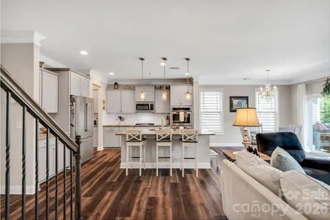 a living room with furniture and a ceiling fan