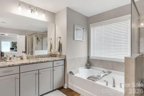 a en suite bathroom with a double vanity sink a mirror and a shower
