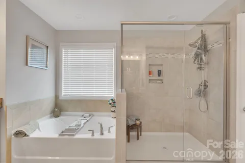 a bedroom with a bed a ceiling fan and a dresser