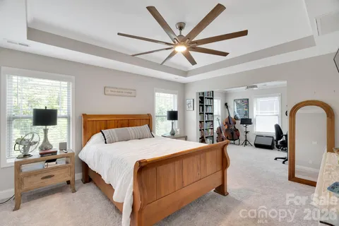 a bed room with furniture and a flat screen tv