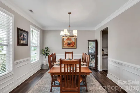 a view of a dining room with furniture and a chandelier