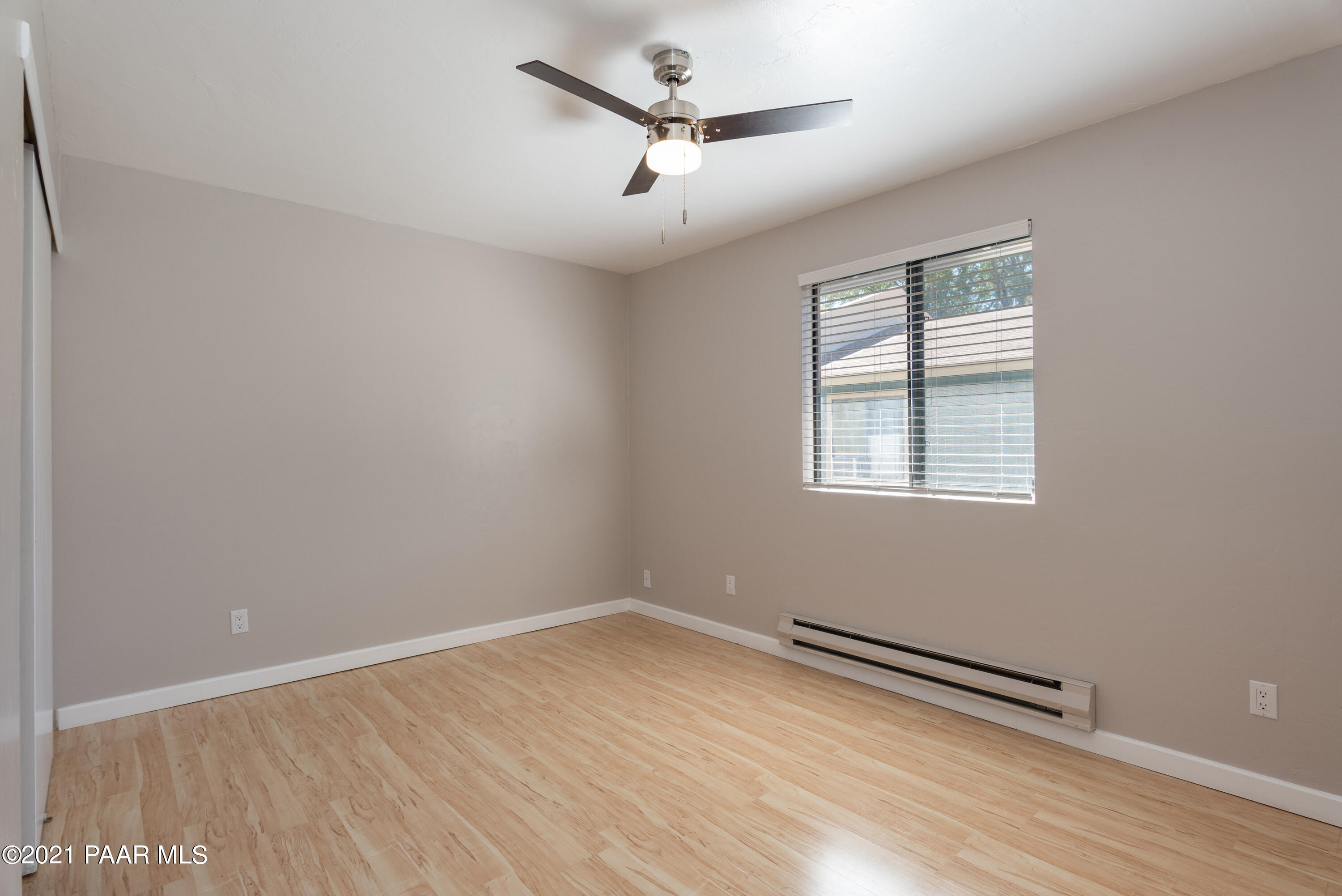 845 Sunset Avenue, Unit D Prescott, AZ 86305 - Photo 12 of 18 an empty room with wooden floor and windows