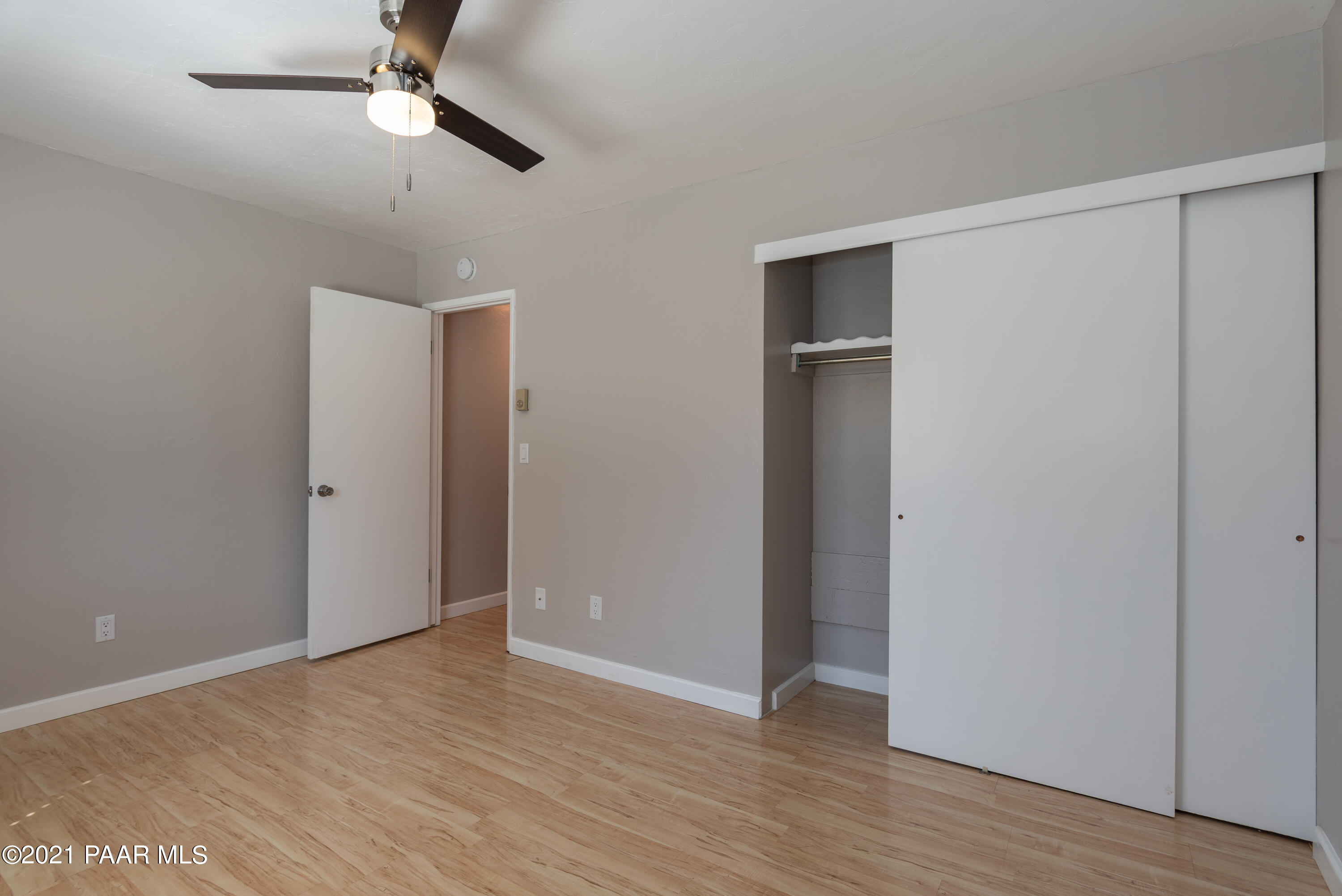 845 Sunset Avenue, Unit D Prescott, AZ 86305 - Photo 13 of 18 an empty room with wooden floor closet and ceiling fan