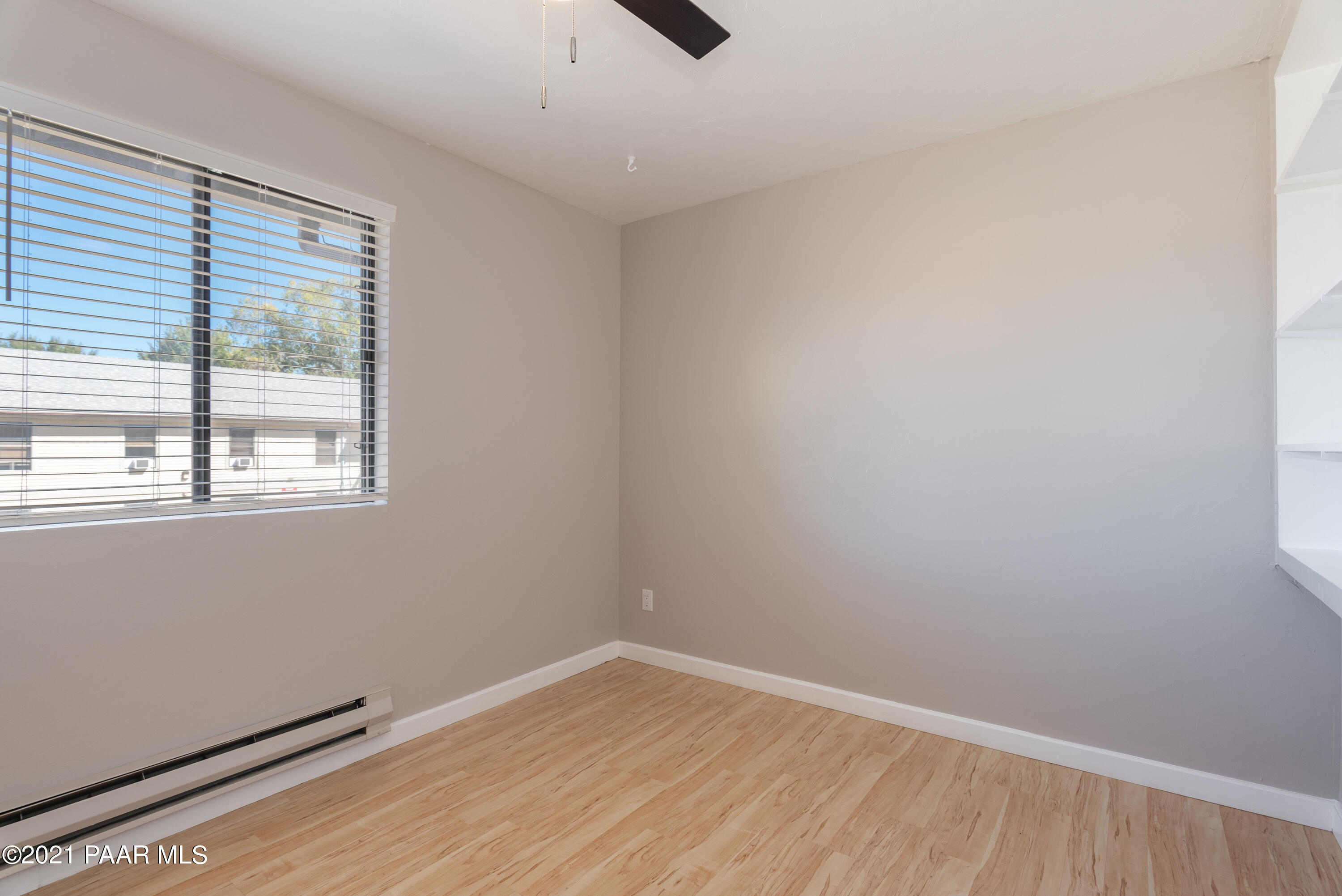 845 Sunset Avenue, Unit D Prescott, AZ 86305 - Photo 16 of 18 wooden floor in an empty room with a window