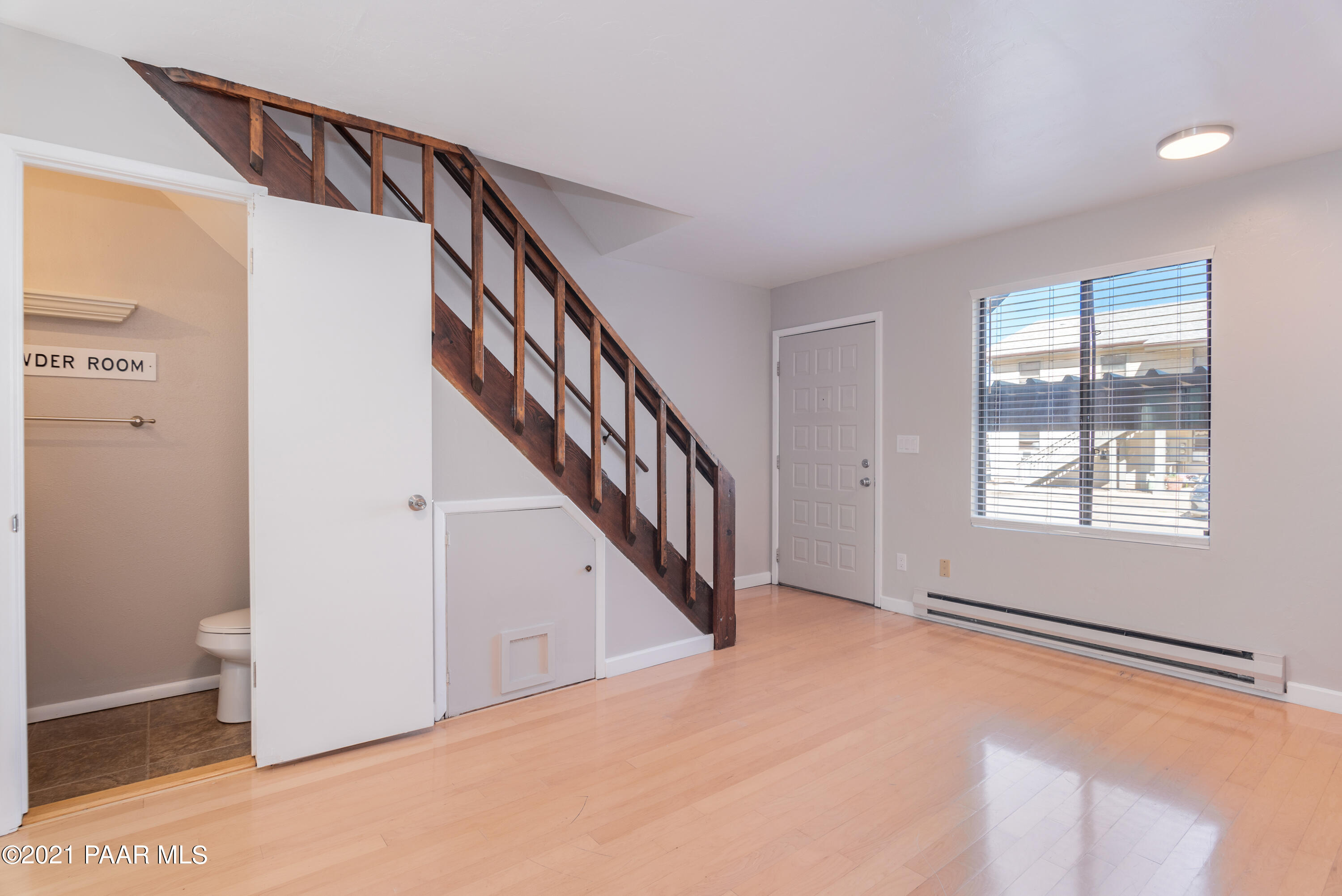 845 Sunset Avenue, Unit D Prescott, AZ 86305 - Photo 4 of 18 a view of an empty room with wooden floor and stairs