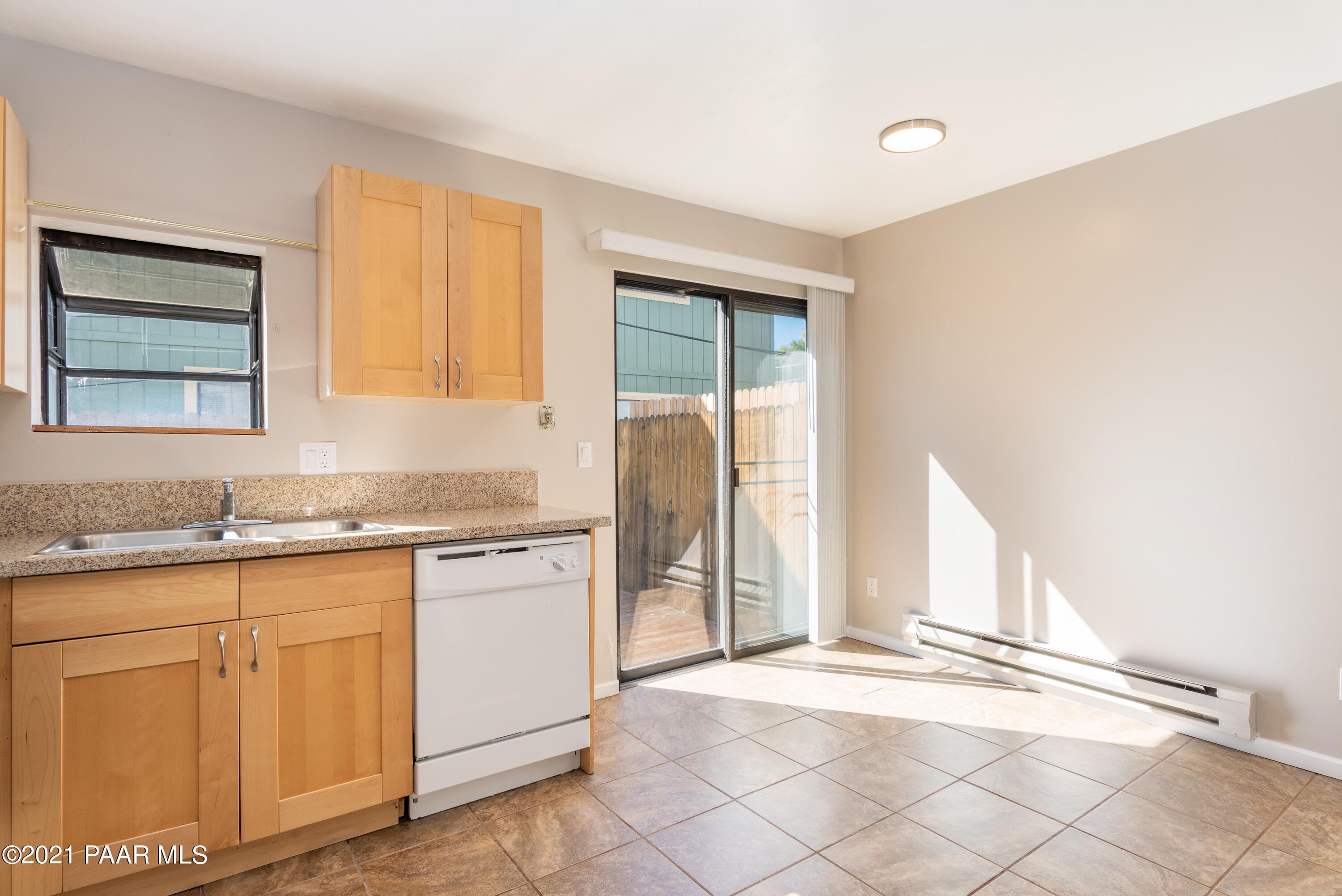 845 Sunset Avenue, Unit D Prescott, AZ 86305 - Photo 7 of 18 a kitchen with granite countertop white cabinets and white appliances