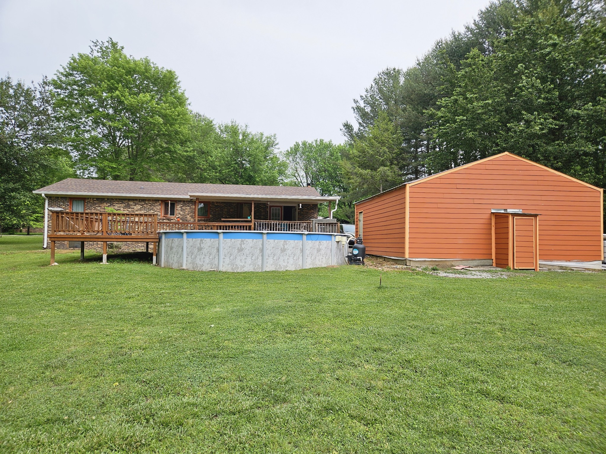 189 Sunset View Estill Springs, TN 37330 - Photo 5 of 22 a backyard of a house with wooden fence and large trees