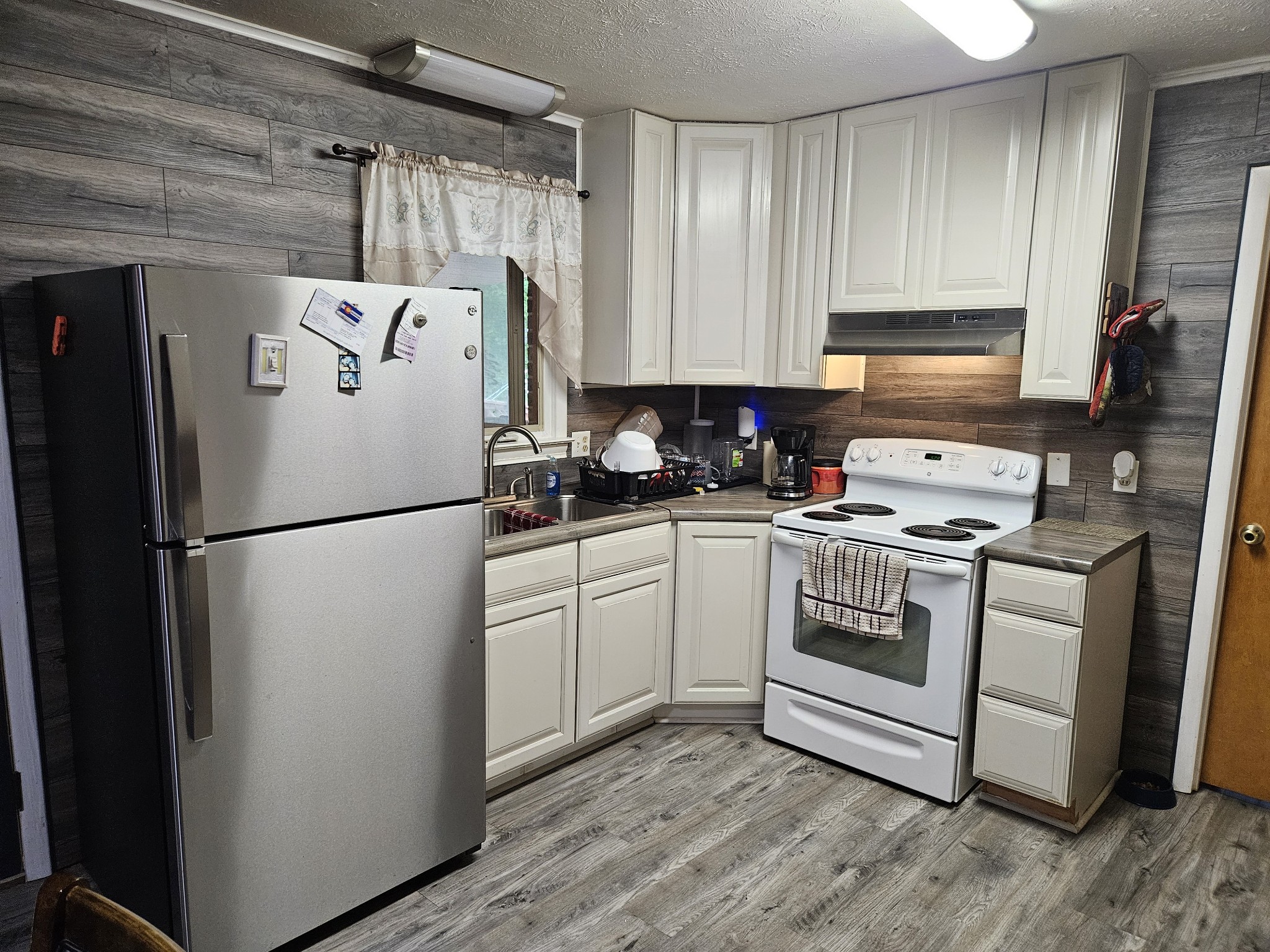 189 Sunset View Estill Springs, TN 37330 - Photo 6 of 22 a white refrigerator freezer sitting in a kitchen