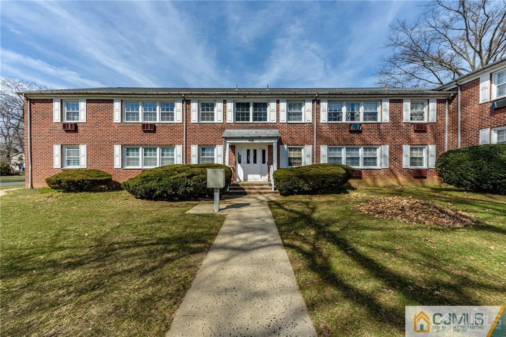 48 Stonehurst Boulevard, Unit E Freehold, NJ 07728 - Photo 1 of 15 a front view of a residential apartment building with a yard