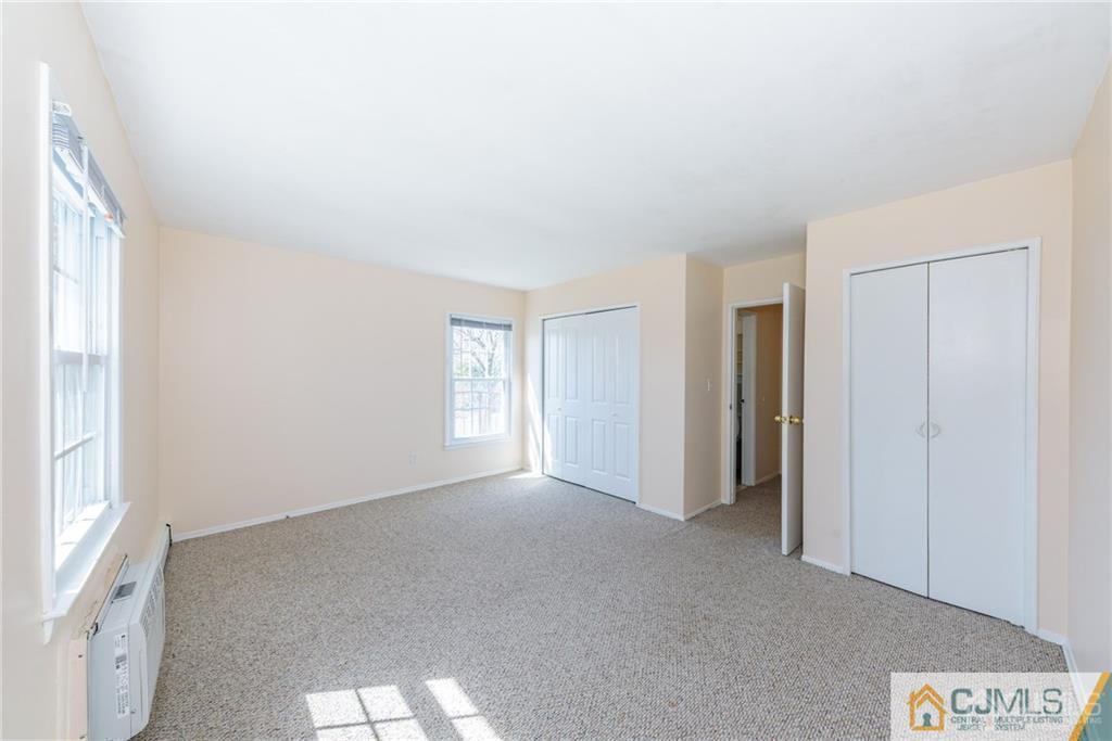 48 Stonehurst Boulevard, Unit E Freehold, NJ 07728 - Photo 14 of 15 a view of an empty room with a window