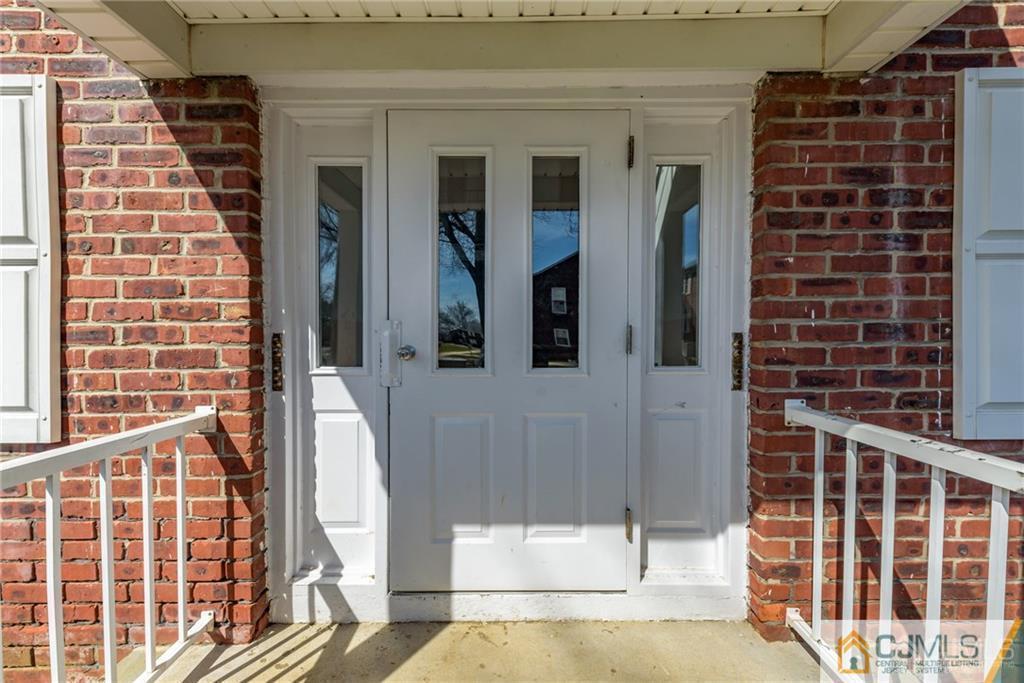 48 Stonehurst Boulevard, Unit E Freehold, NJ 07728 - Photo 2 of 15 a view of a balcony with door