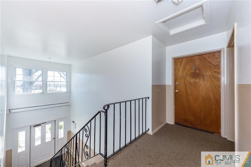 48 Stonehurst Boulevard, Unit E Freehold, NJ 07728 - Photo 3 of 15 a view of hallway with stairs