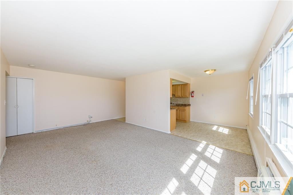 48 Stonehurst Boulevard, Unit E Freehold, NJ 07728 - Photo 7 of 15 a view of an empty room with a window