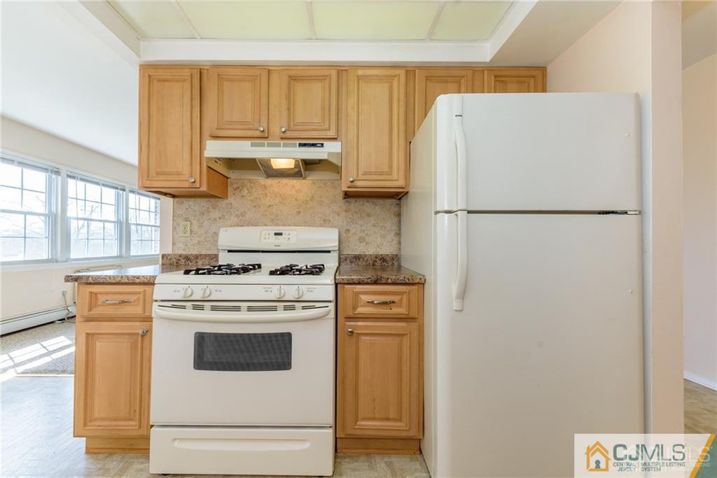 48 Stonehurst Boulevard, Unit E Freehold, NJ 07728 - Photo 10 of 15 a white refrigerator freezer sitting in a kitchen