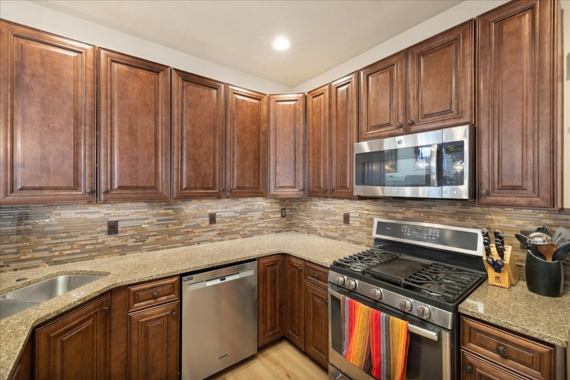 403 Fly Line Drive Silverthorne, CO 80498 - Photo 11 of 35 a kitchen with granite countertop a stove sink and cabinets