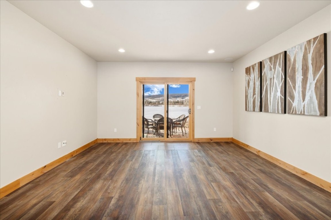 403 Fly Line Drive Silverthorne, CO 80498 - Photo 19 of 35 a view of an empty room with wooden floor and a window