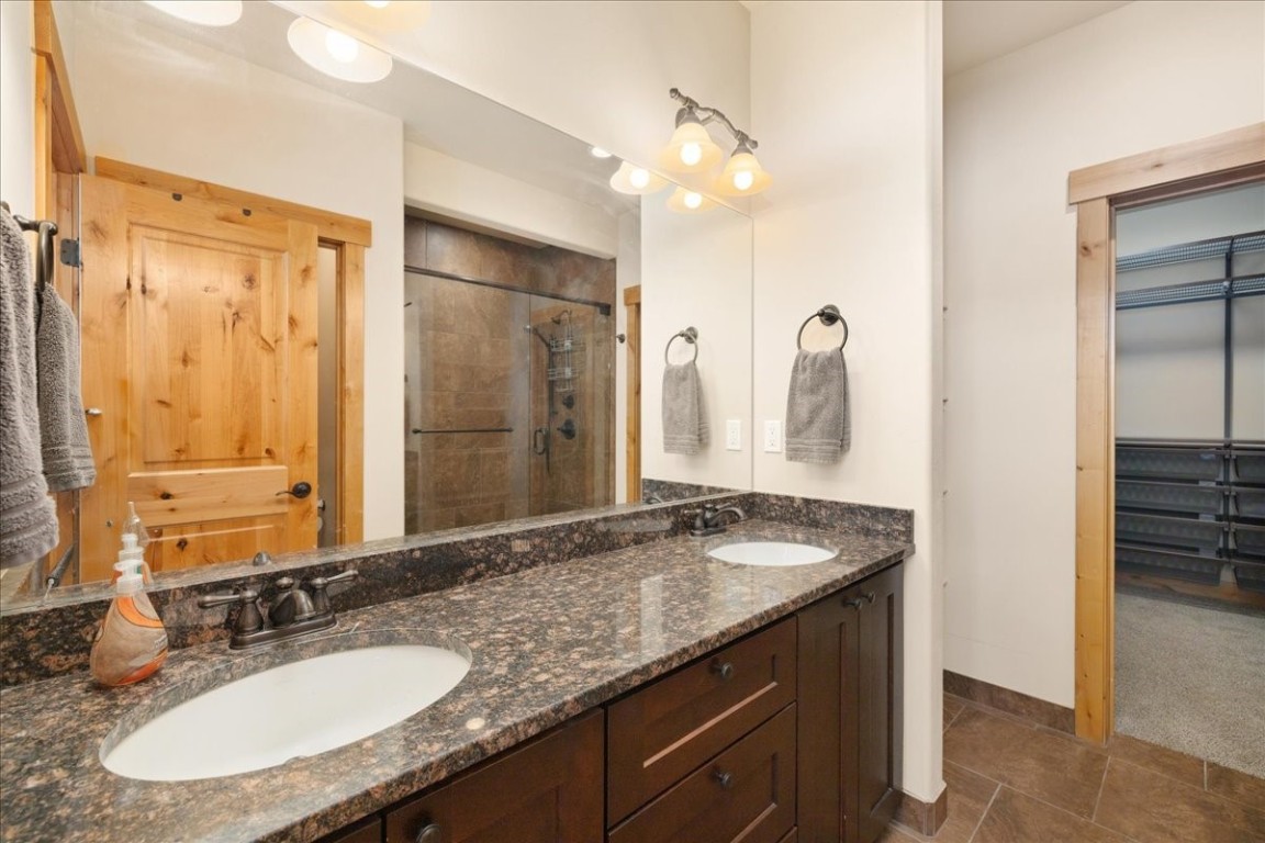 403 Fly Line Drive Silverthorne, CO 80498 - Photo 24 of 35 a bathroom with a granite countertop sink and a mirror