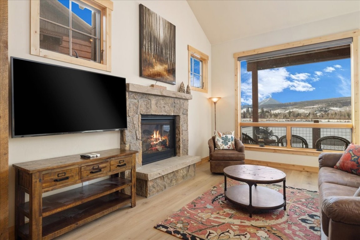 403 Fly Line Drive Silverthorne, CO 80498 - Photo 7 of 35 a living room with furniture a flat screen tv and a fireplace