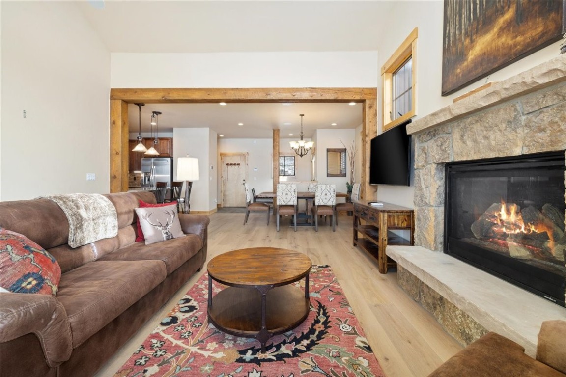 403 Fly Line Drive Silverthorne, CO 80498 - Photo 8 of 35 a living room with furniture a fireplace and a flat screen tv