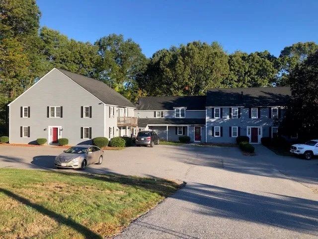 a view of a house with pool and sitting area