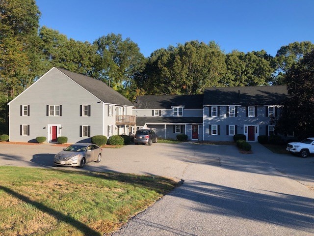 a view of a house with pool and sitting area