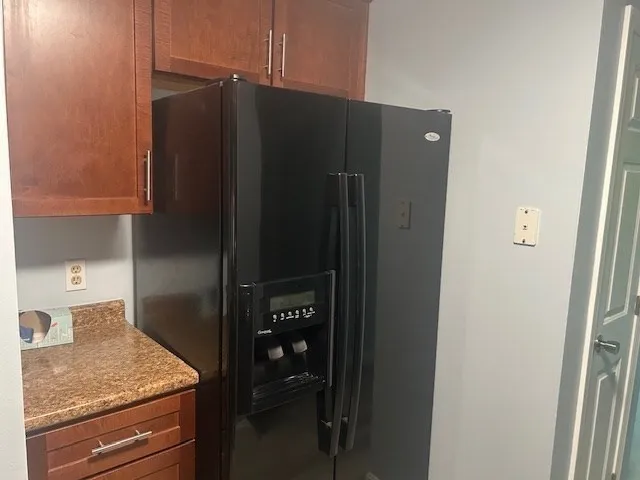 a bathroom with a granite countertop sink and shower