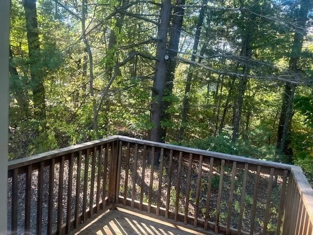 a view of balcony with wooden fence