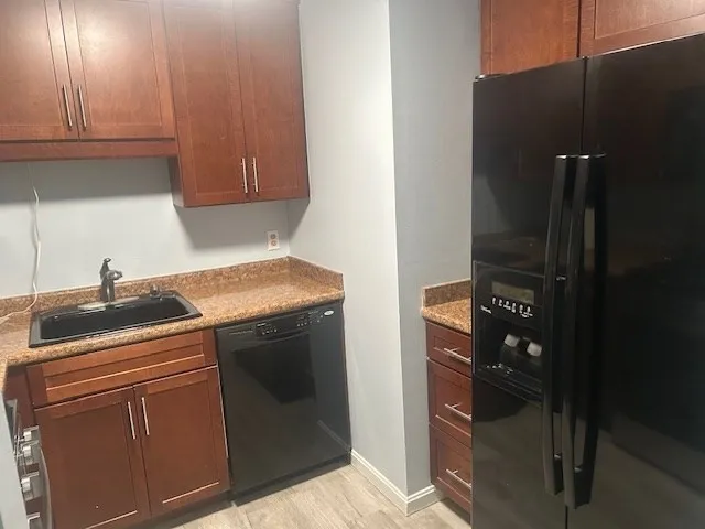 a kitchen with stainless steel appliances granite countertop a refrigerator and a stove