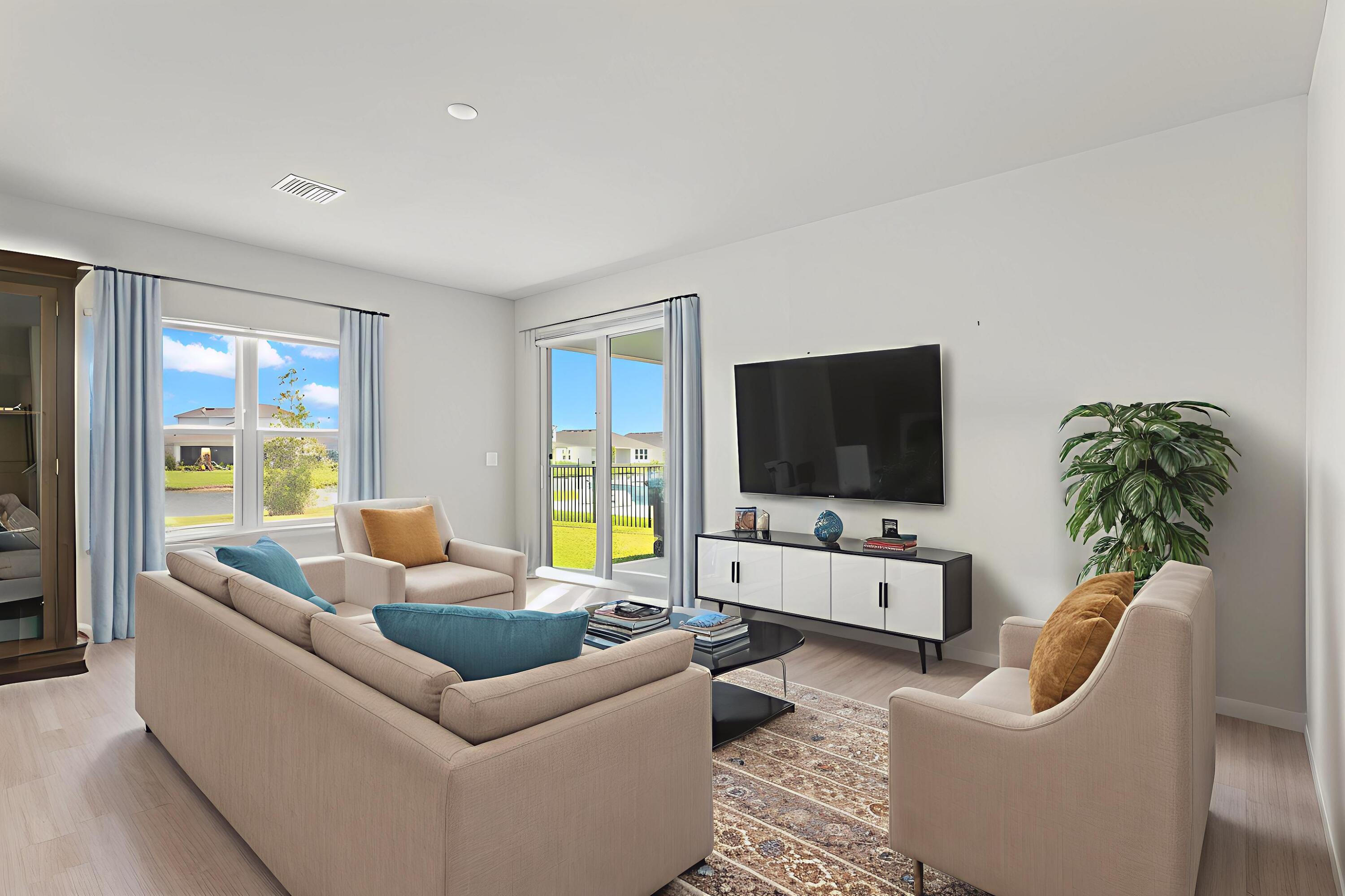 12291 Southwest Forli Way Port Port St. Lucie, FL 34987 - Photo 11 of 48 a living room with furniture and a flat screen tv