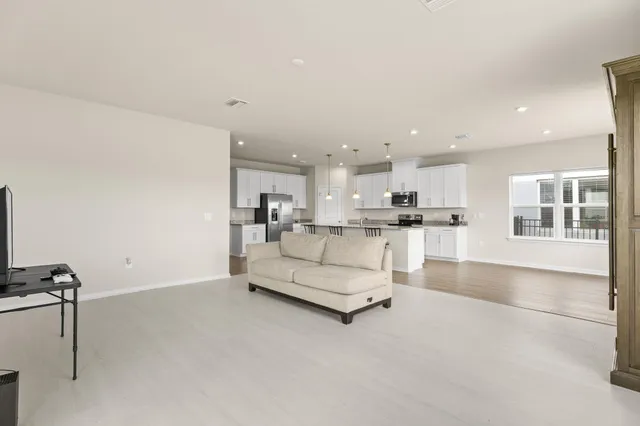 a living room with kitchen view and a view of kitchen