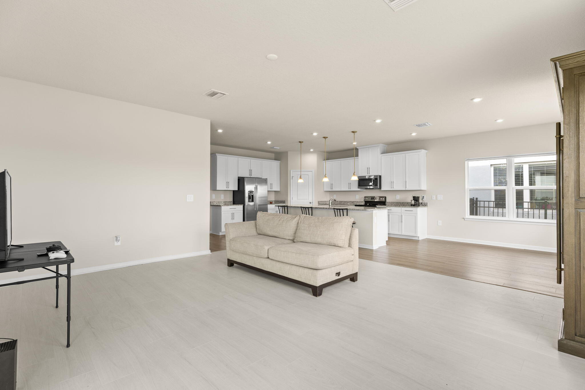 12291 Southwest Forli Way Port Port St. Lucie, FL 34987 - Photo 14 of 48 a living room with kitchen view and a view of kitchen