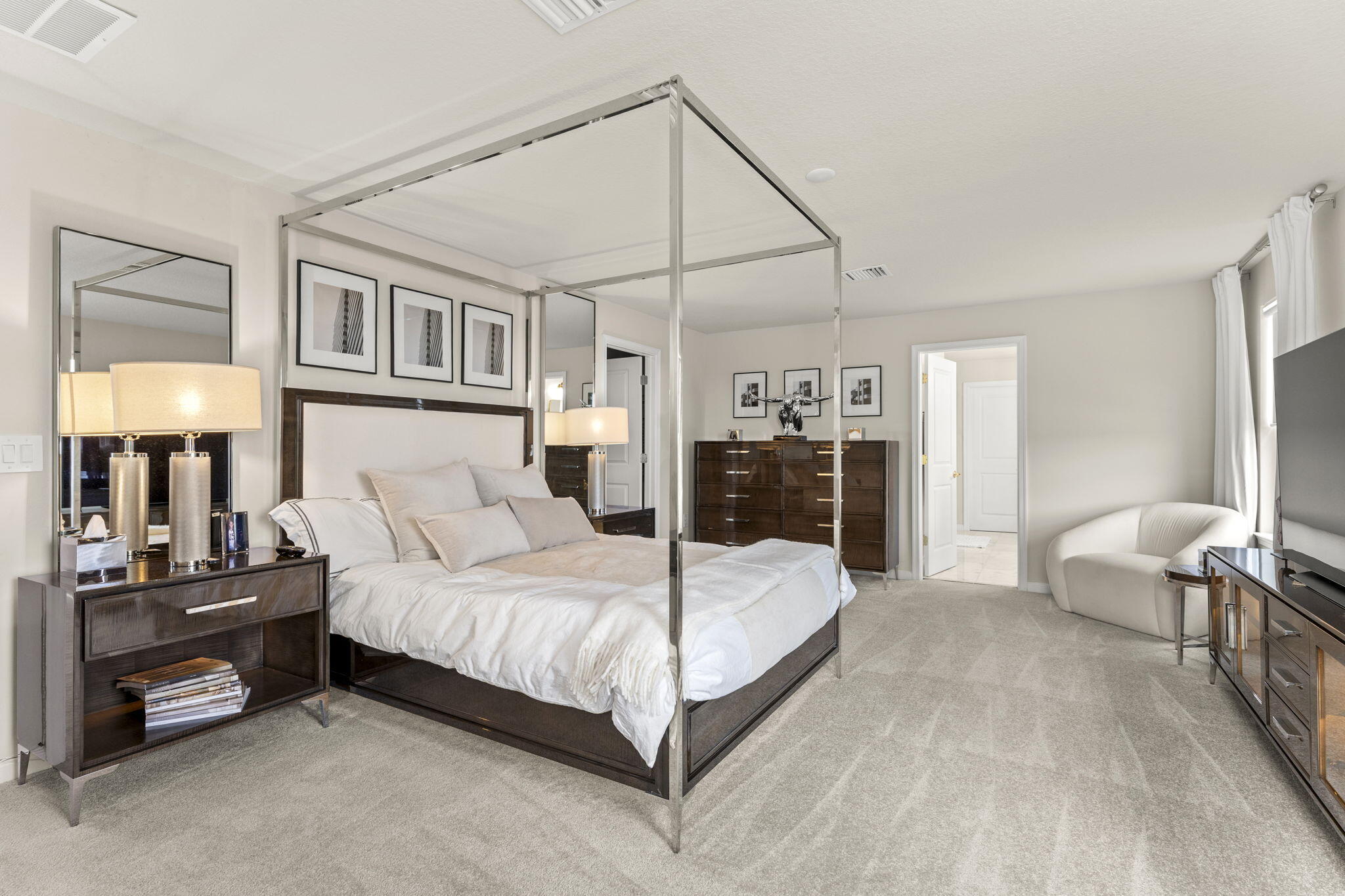 12291 Southwest Forli Way Port Port St. Lucie, FL 34987 - Photo 21 of 48 a bedroom with a bed and a lamp on table