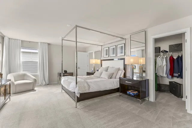 a spacious bedroom with a bed and a couch