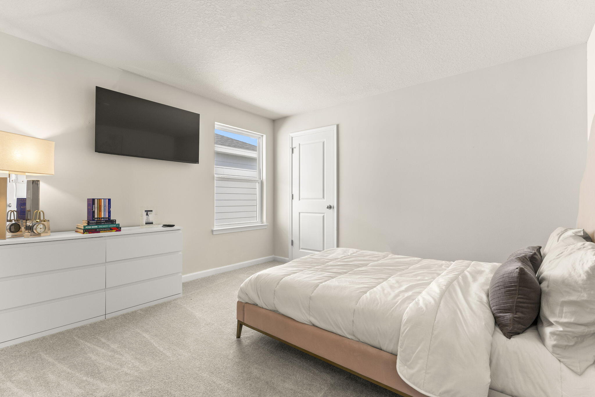 12291 Southwest Forli Way Port Port St. Lucie, FL 34987 - Photo 30 of 48 a bedroom with a bed tv and window