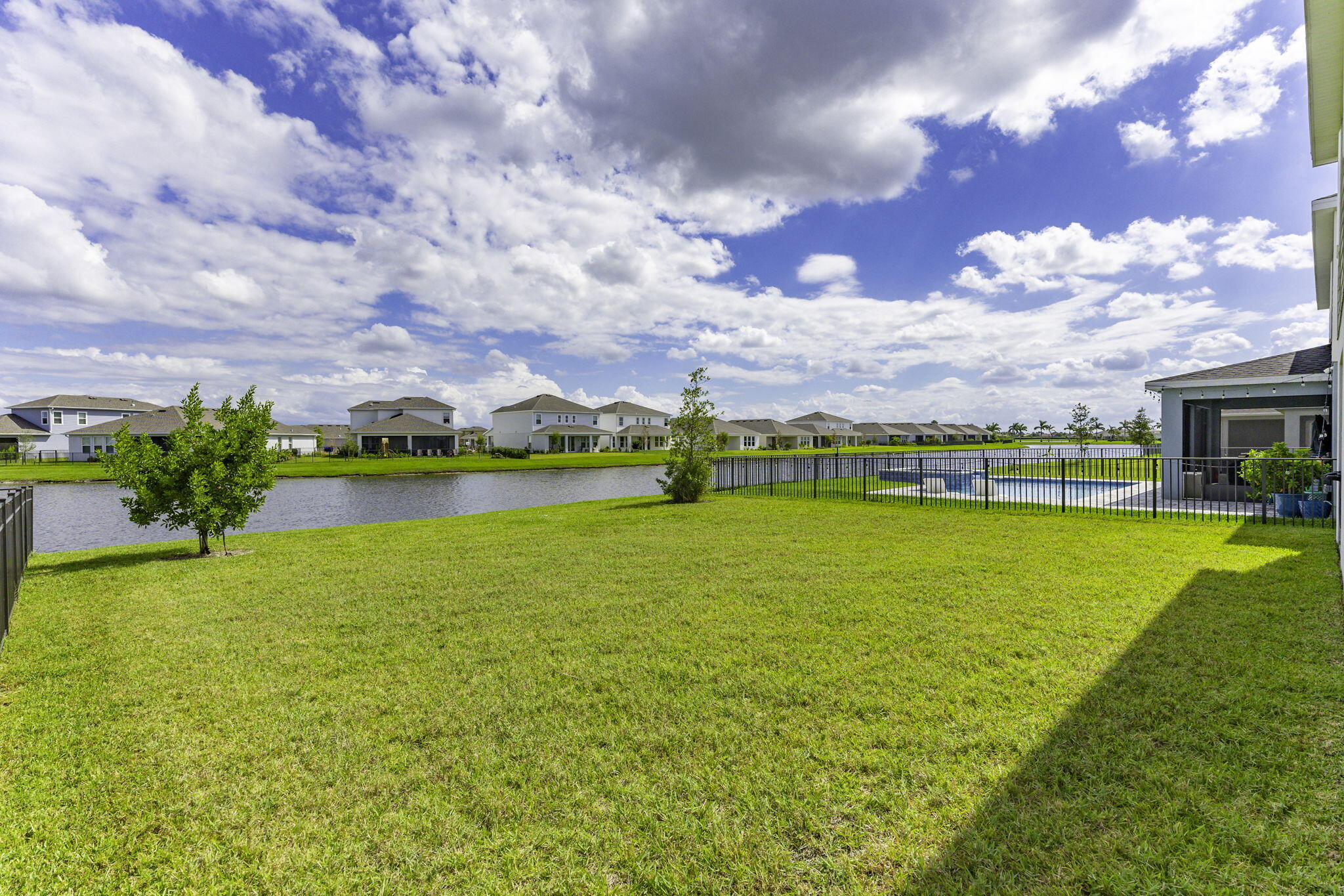 12291 Southwest Forli Way Port Port St. Lucie, FL 34987 - Photo 33 of 48 a view of a lake with a house in the background
