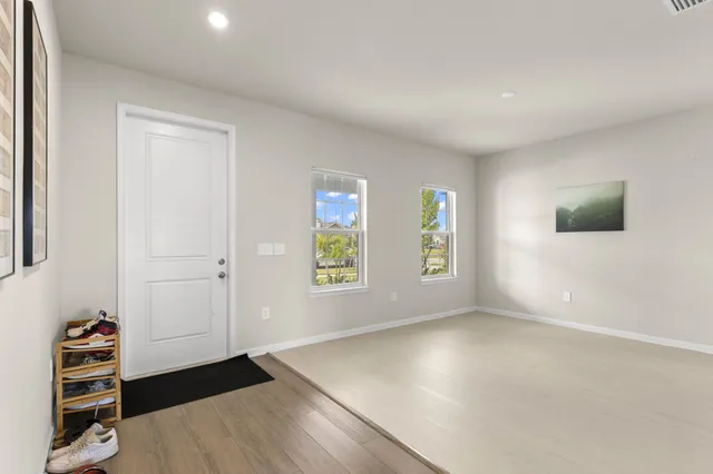 wooden floor in an empty room with a window