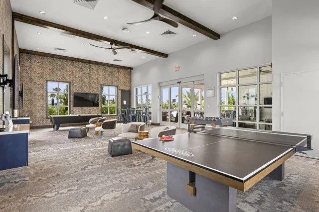 a dining room with furniture a window and wooden floor