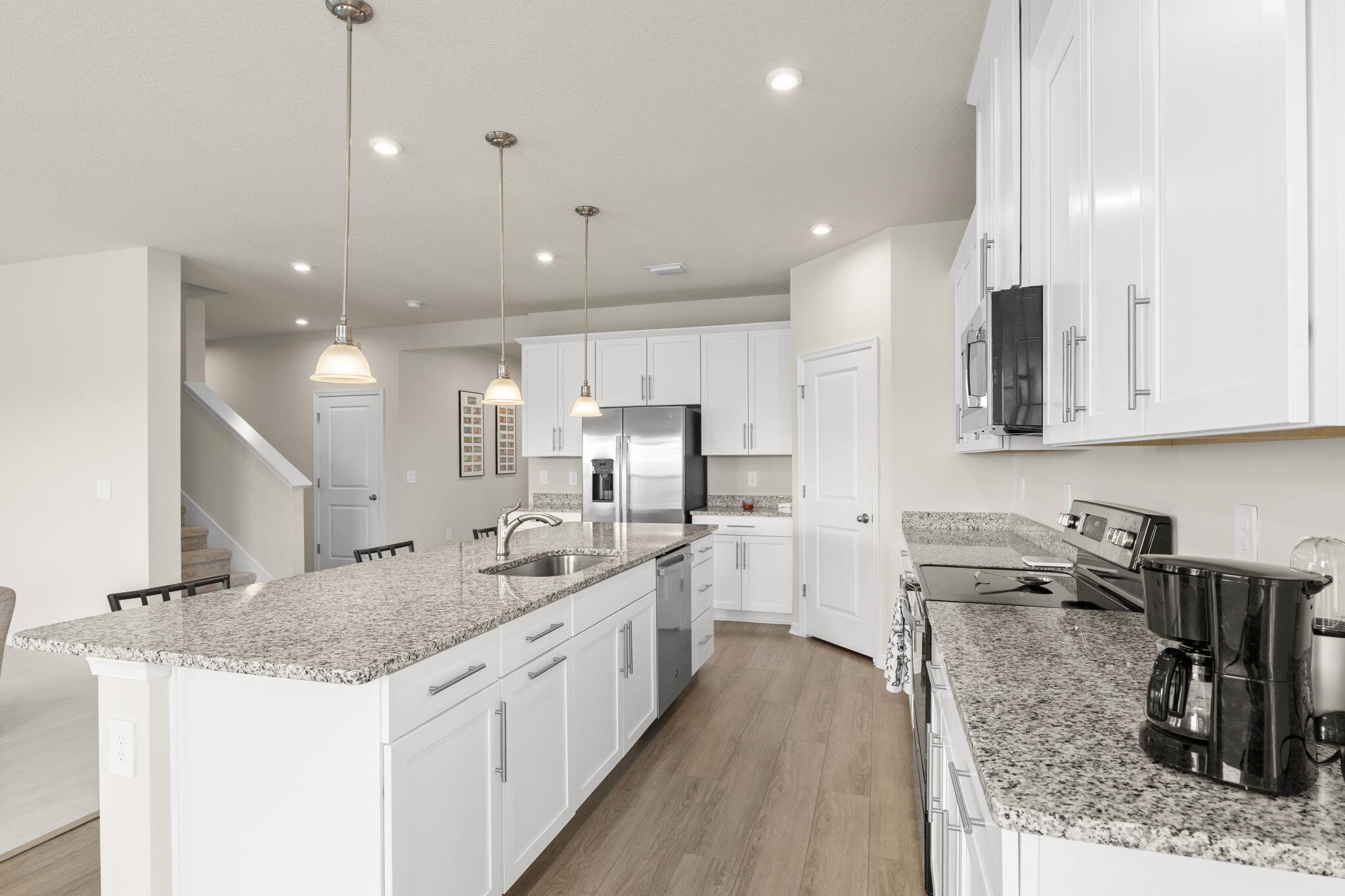 12291 Southwest Forli Way Port Port St. Lucie, FL 34987 - Photo 8 of 48 a kitchen with stainless steel appliances kitchen island granite countertop a sink stove and cabinets