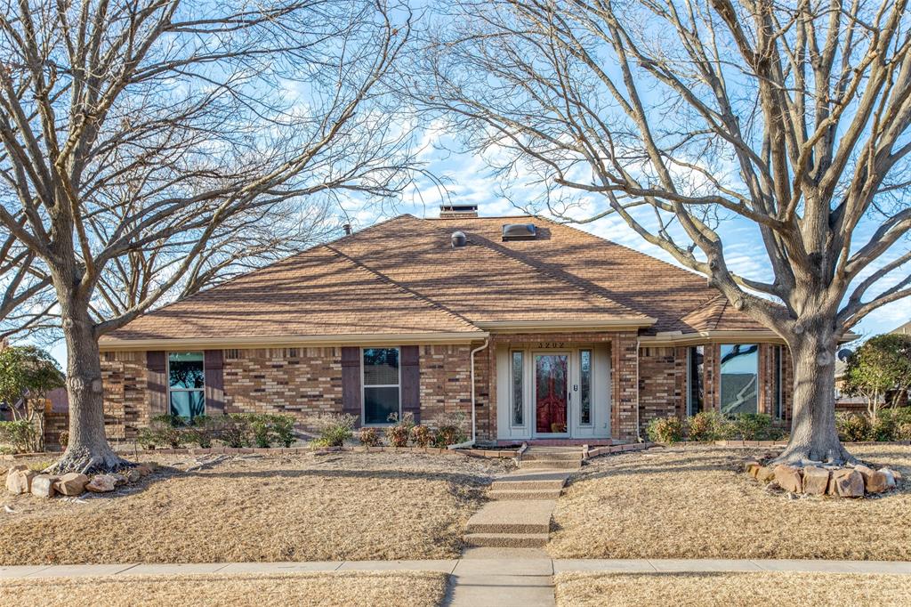 3202 Ridge Oak Drive Garland, TX 75044 - Photo 1 of 25 front view of a brick house with large windows