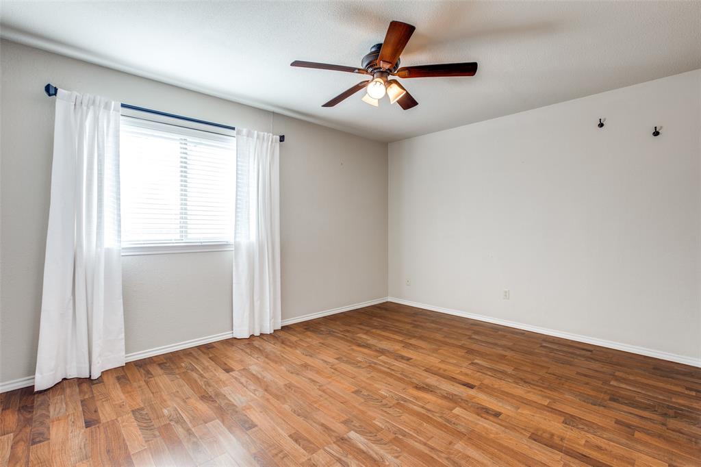 3202 Ridge Oak Drive Garland, TX 75044 - Photo 17 of 25 an empty room with wooden floor and windows