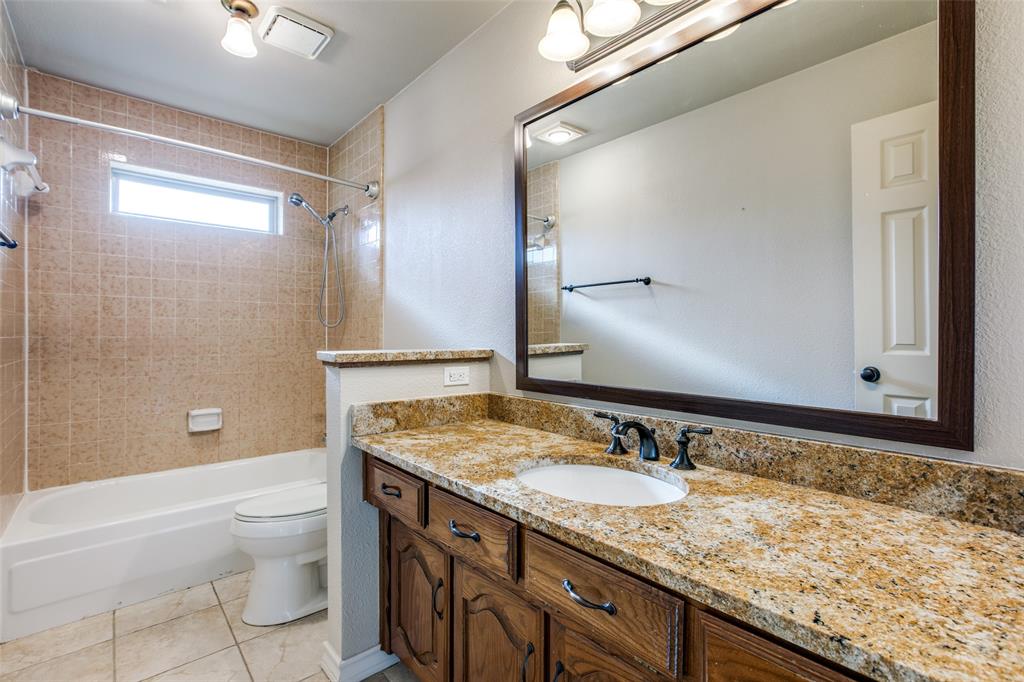 3202 Ridge Oak Drive Garland, TX 75044 - Photo 18 of 25 a bathroom with a granite countertop sink a toilet and shower
