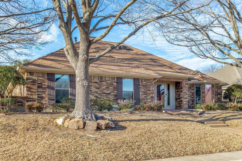 3202 Ridge Oak Drive Garland, TX 75044 - Photo 2 of 25 a front view of a house with garden