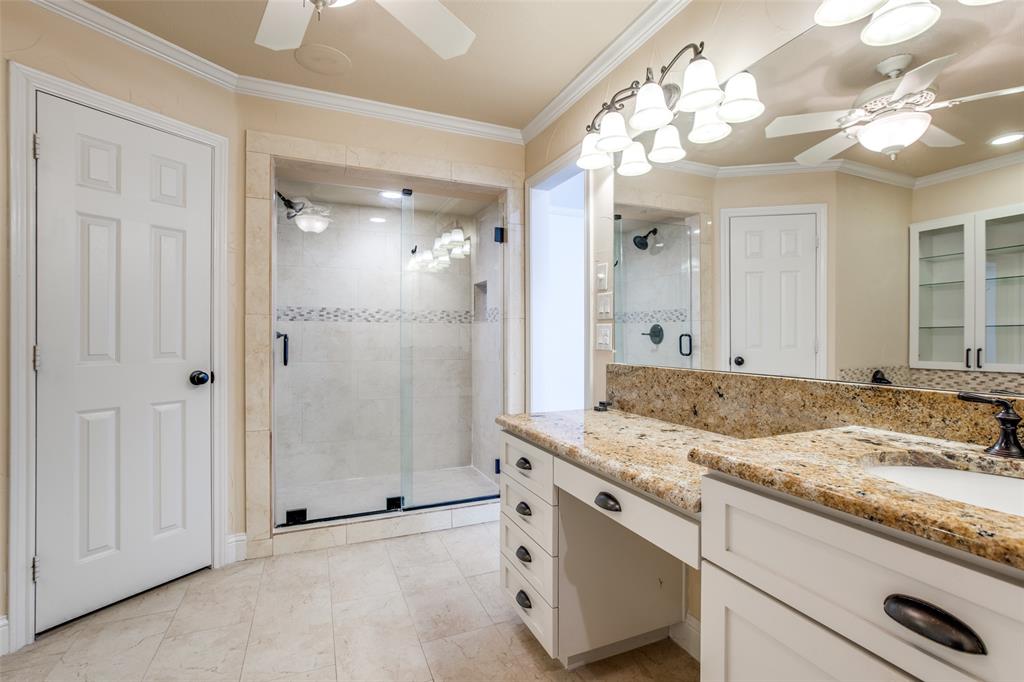 3202 Ridge Oak Drive Garland, TX 75044 - Photo 21 of 25 a bathroom with a granite countertop sink a mirror and a shower